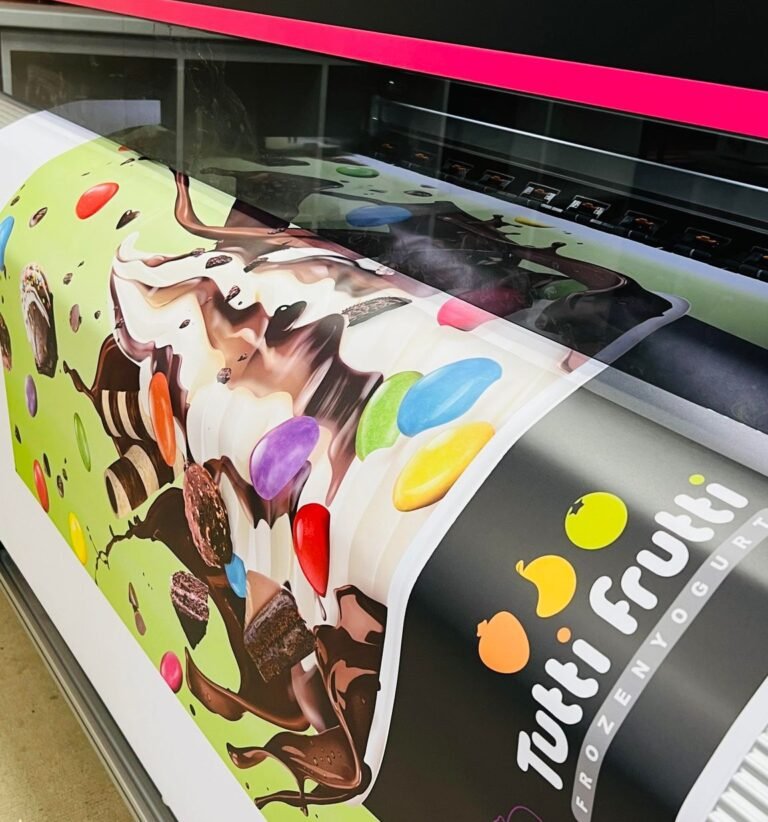 Close-up of a Tutti Frutti graphic being printed on a large format printer