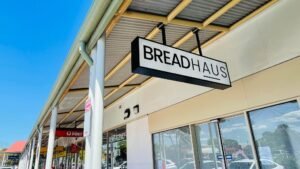 Bread Haus hanging sign under a shopping centre awning
