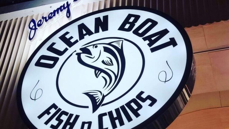 Close-up of the illuminated Ocean Boat Fish n Chips logo sign