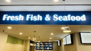 Fresh Fish & Seafood illuminated fascia sign in a shopping centre