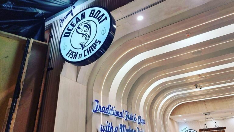 Ocean Boat Fish n Chips round illuminated logo sign in a curved shop interior