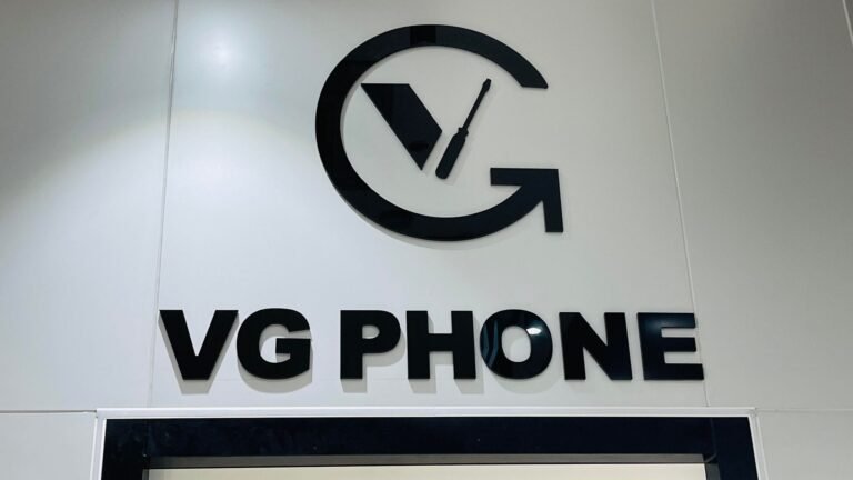 VG Phone black 3D logo and lettering sign on a white wall