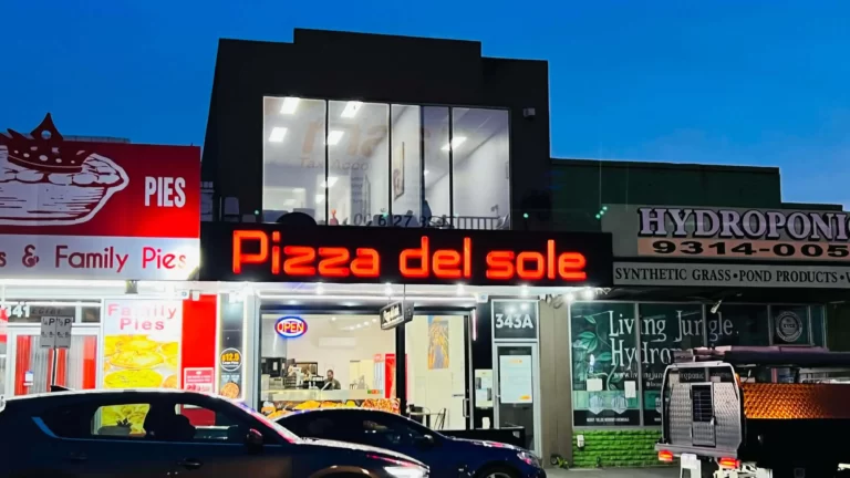 Pizza del Sole illuminated shopfront sign at night