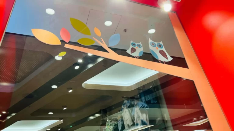 Colourful leaf ceiling feature with lighting in a retail interior